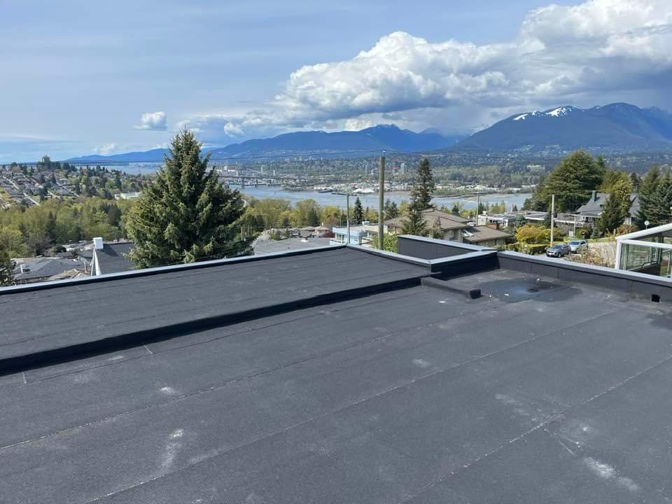 Roof installation crew laying new shingles on a residential home with proper tools and safety gear.