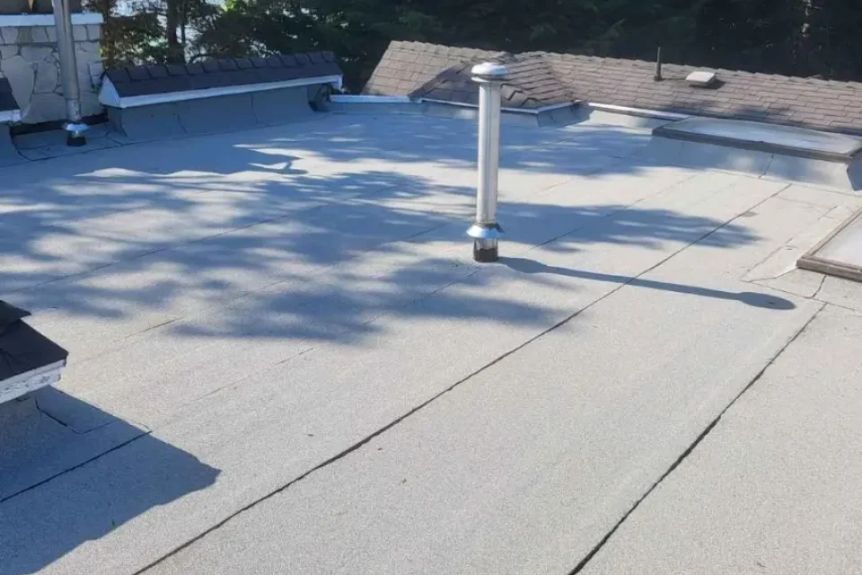Technician performing roof service inspection on a residential home under clear skies.